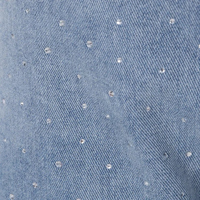 Jean taille haute orné de strass et boutonné sur le côté