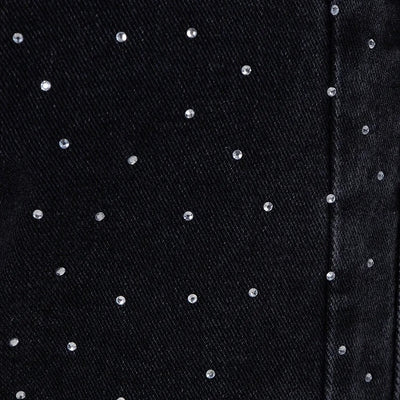 Jean taille haute orné de strass et boutonné sur le côté