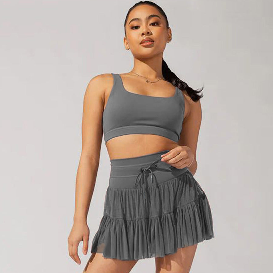 Mini jupe taille haute short intégré plis praticité élégance