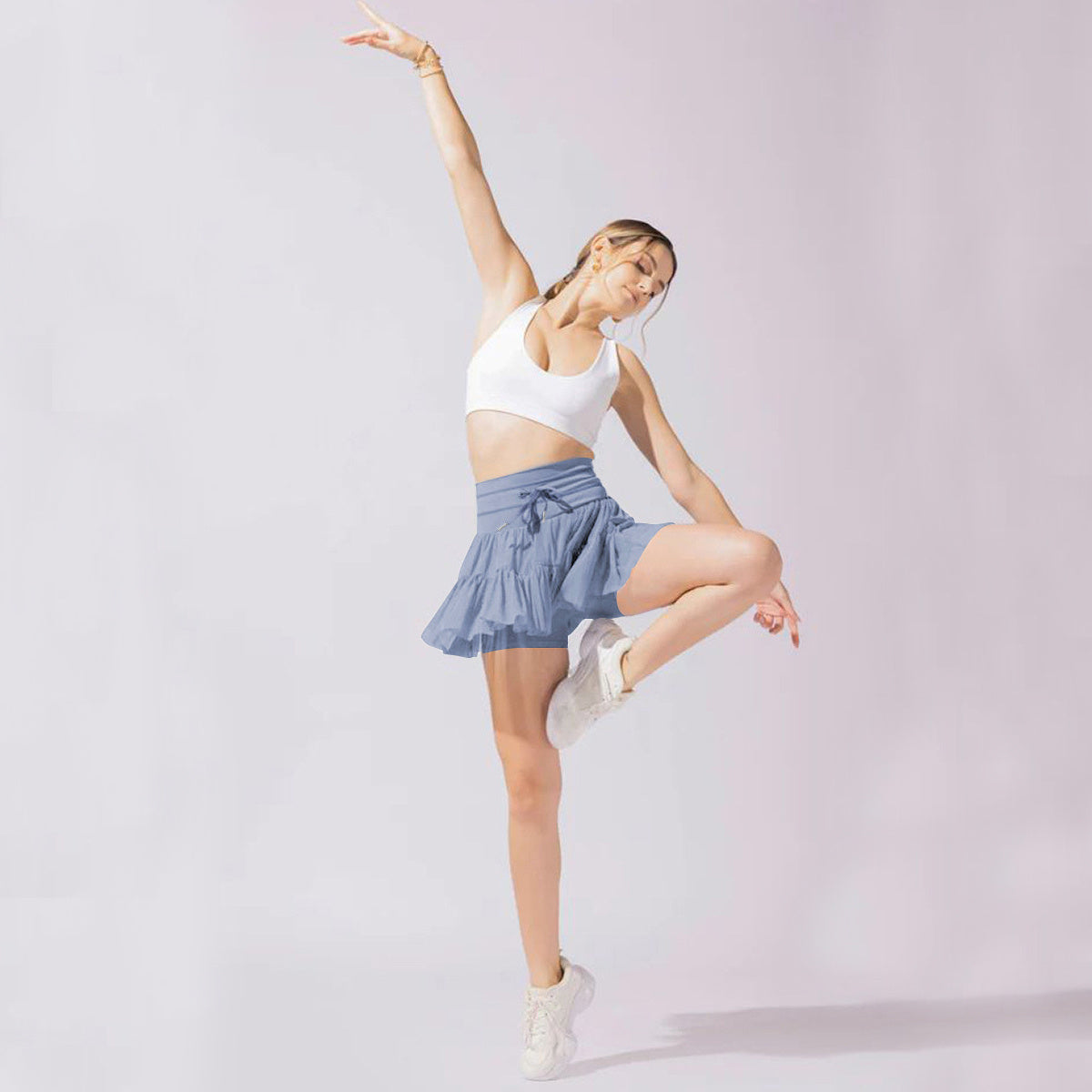 Mini jupe taille haute short intégré plis praticité élégance
